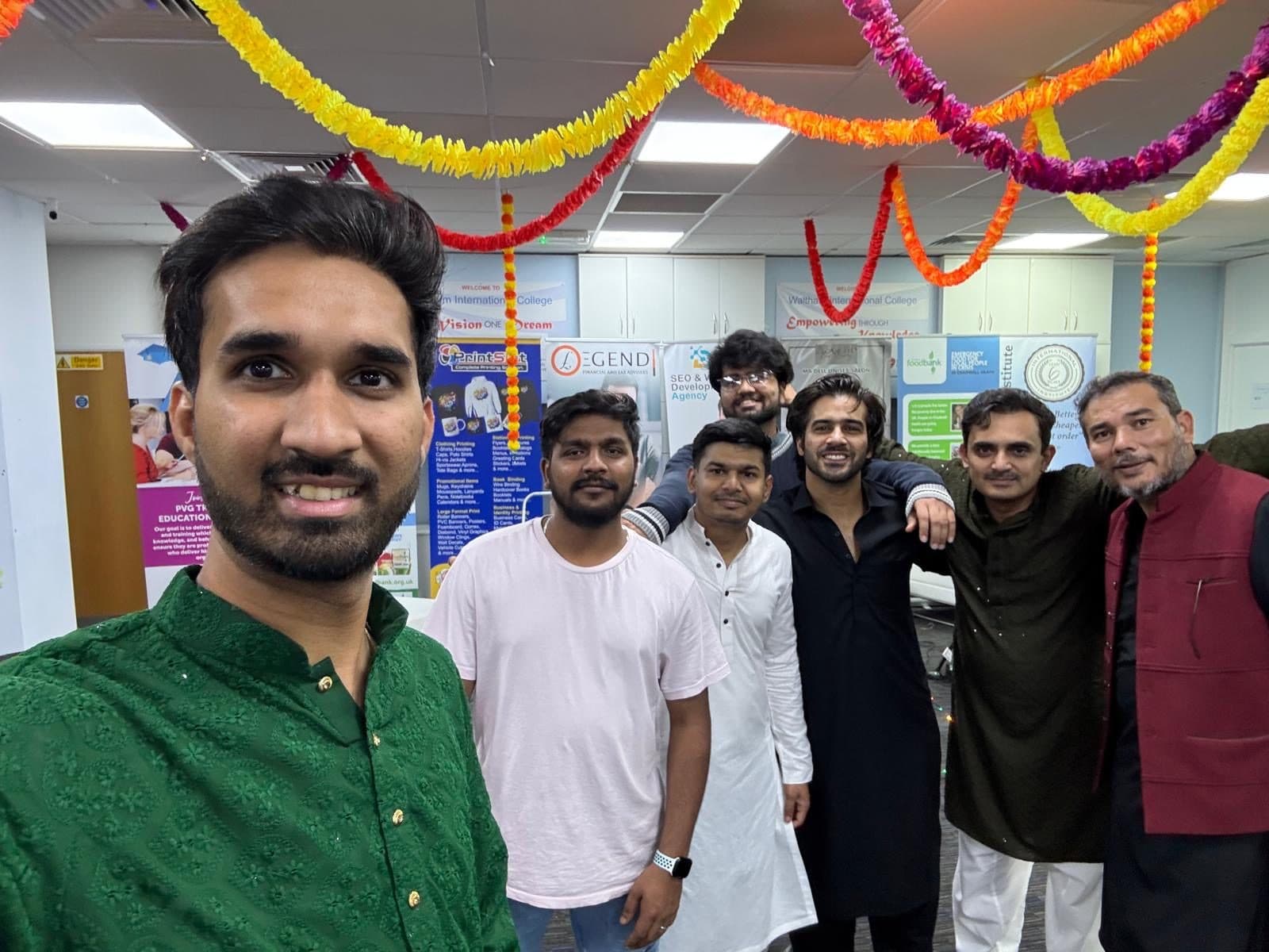 WIC staff and students in traditional kurtas gathered under marigold garlands