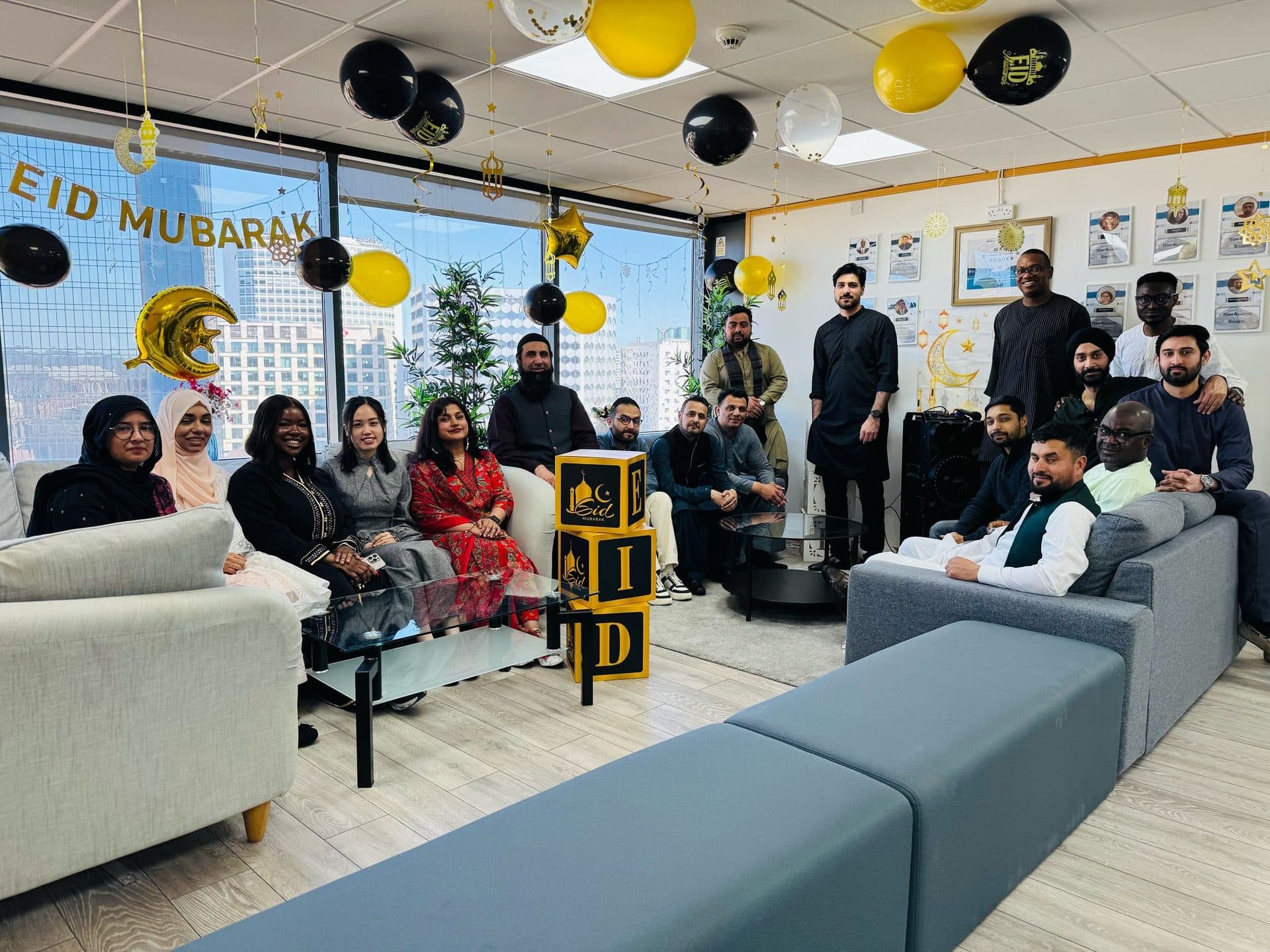 Staff and students in an office decorated with 'Eid Mubarak' balloon garlands, Birmingham campus