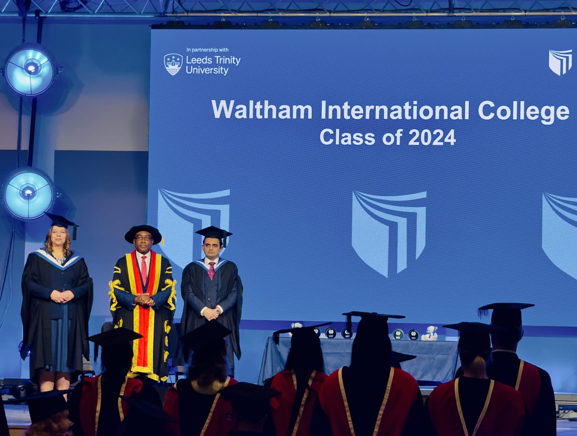 WIC graduates and staff on stage, Class of 2024