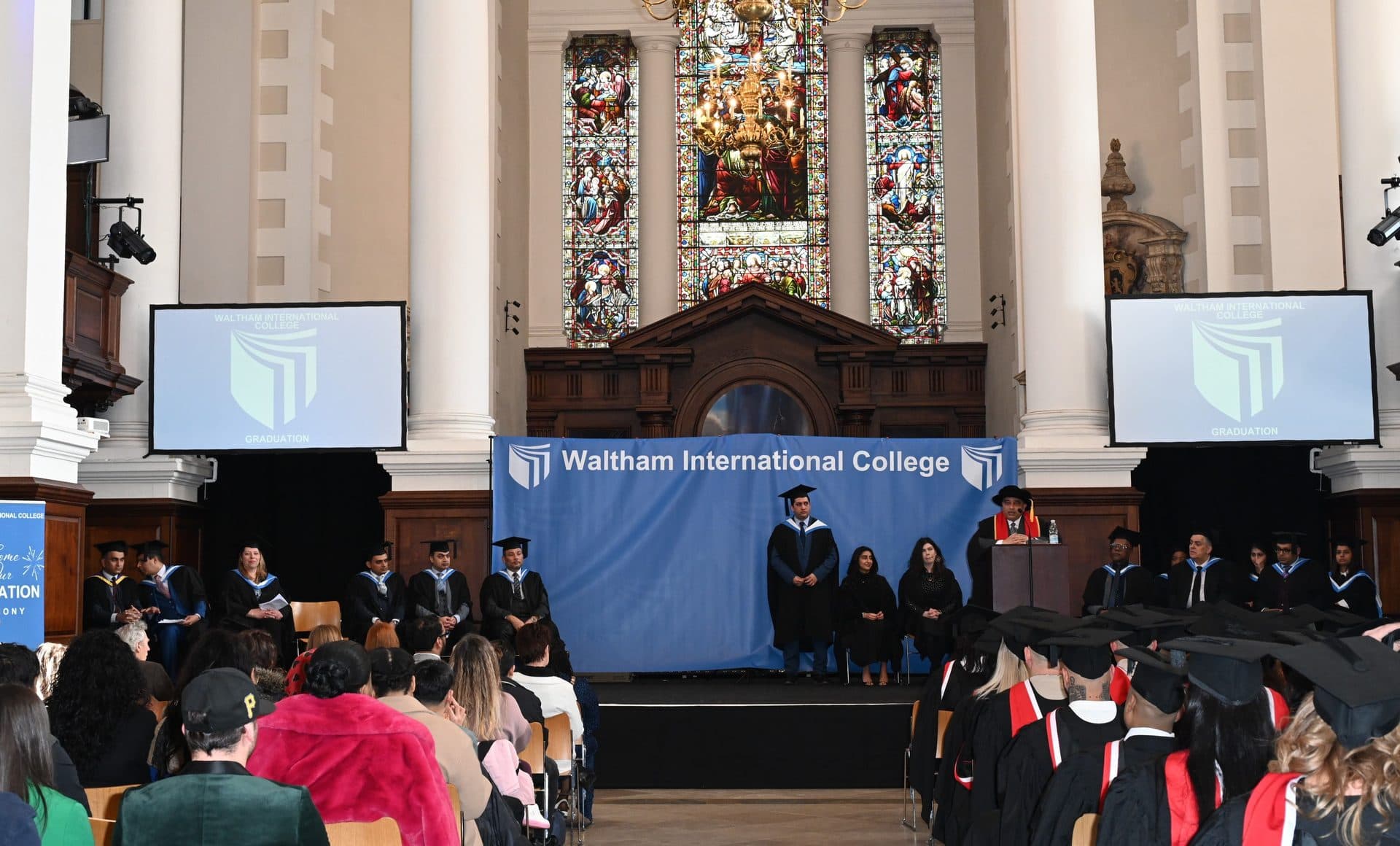 A wide view of the Class of 2024 ceremony hall from another angle, showing the stage and seated audience