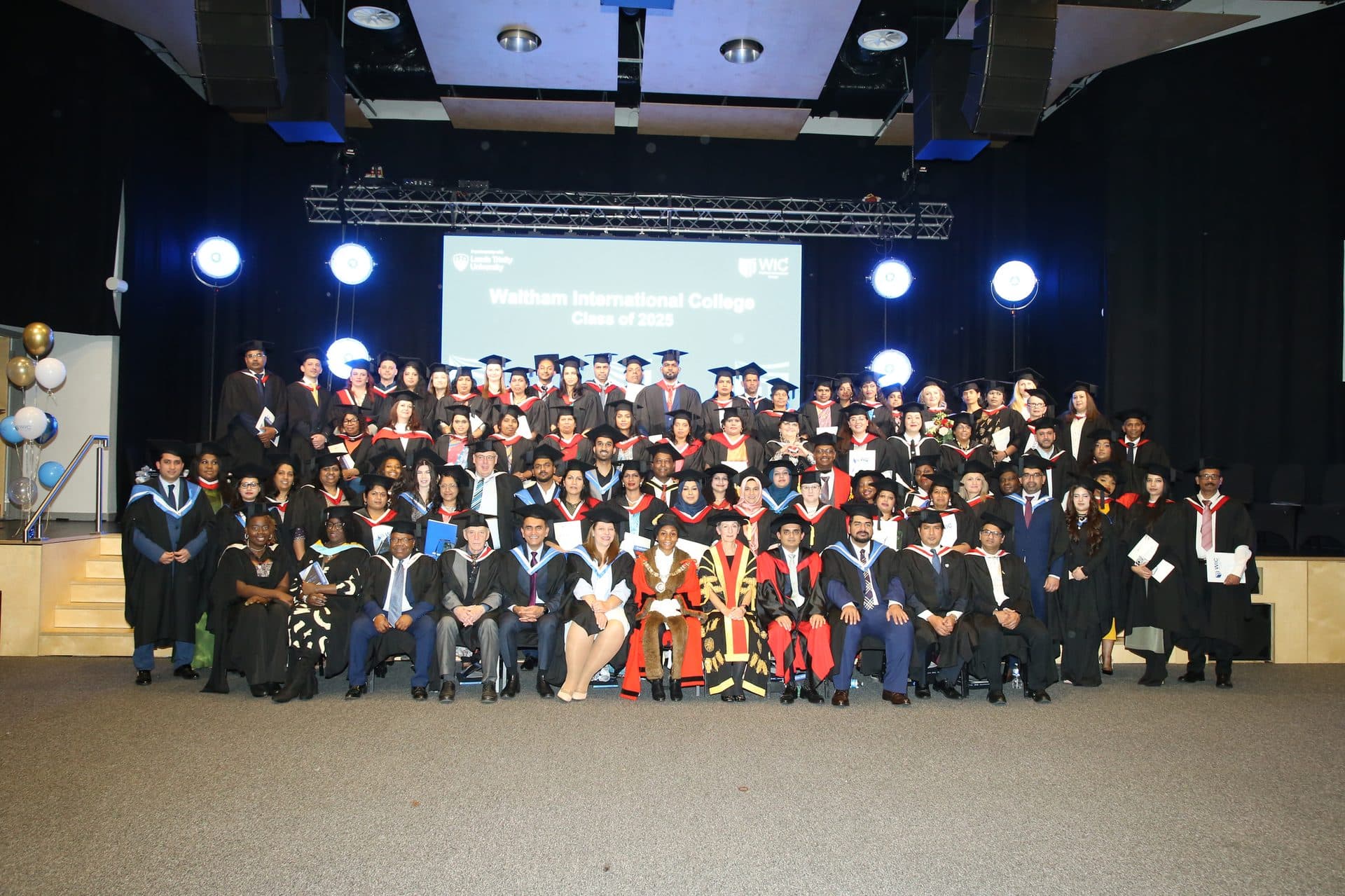 WIC Class of 2025 graduates and staff on stage