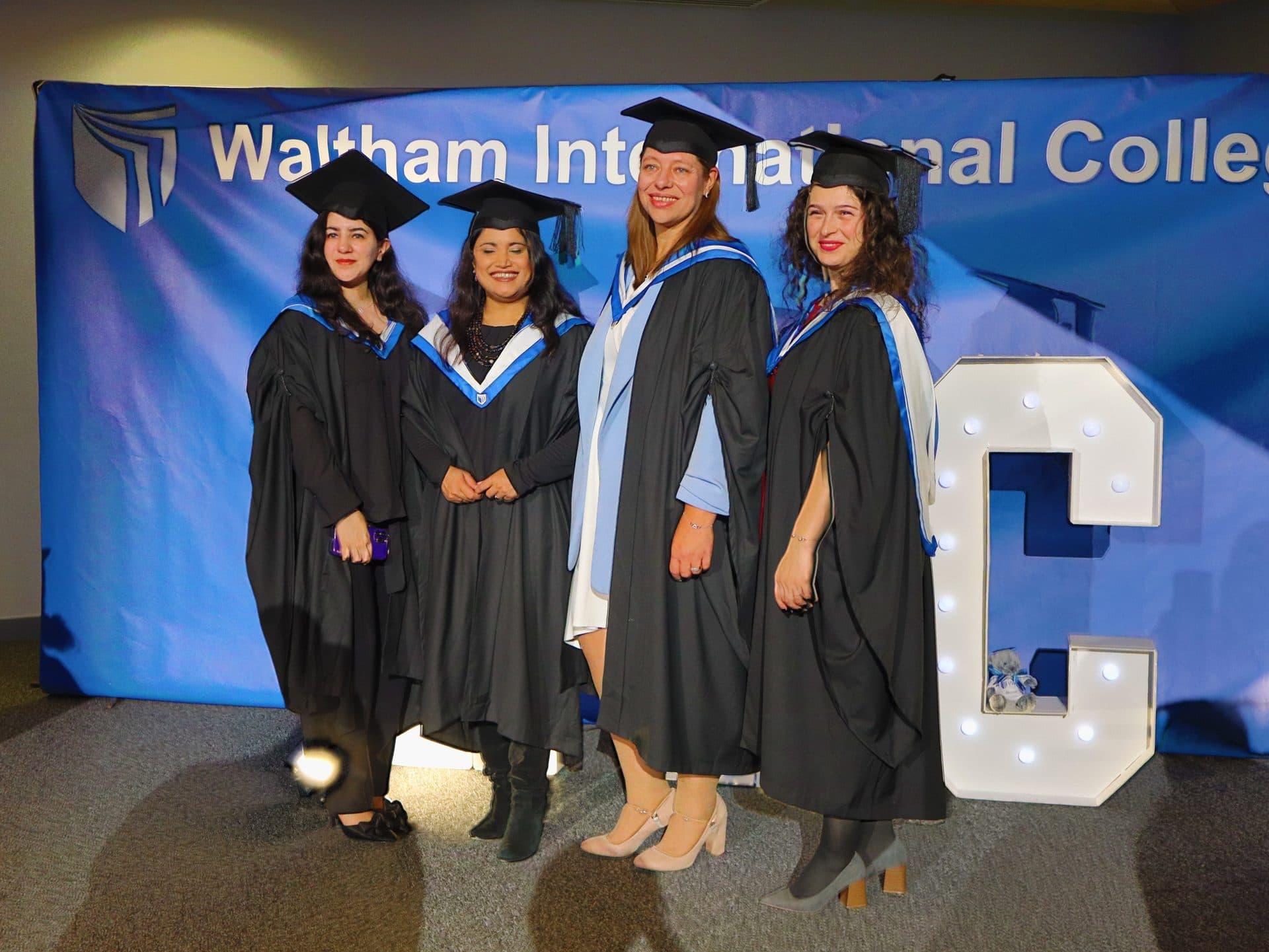 WIC graduates posing at the graduation photo booth