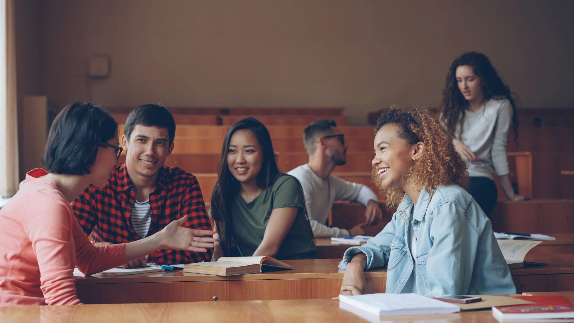 Students chatting together in a lecture hall