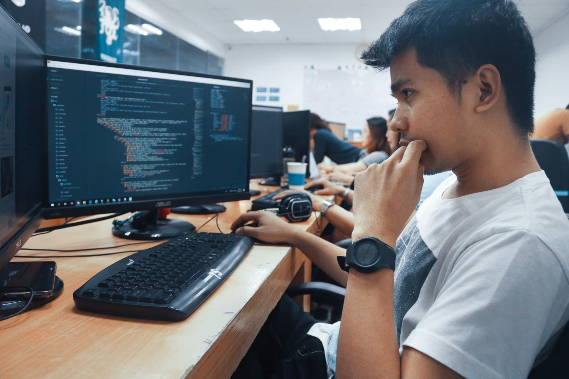 Students working at computer monitors in a lab setting