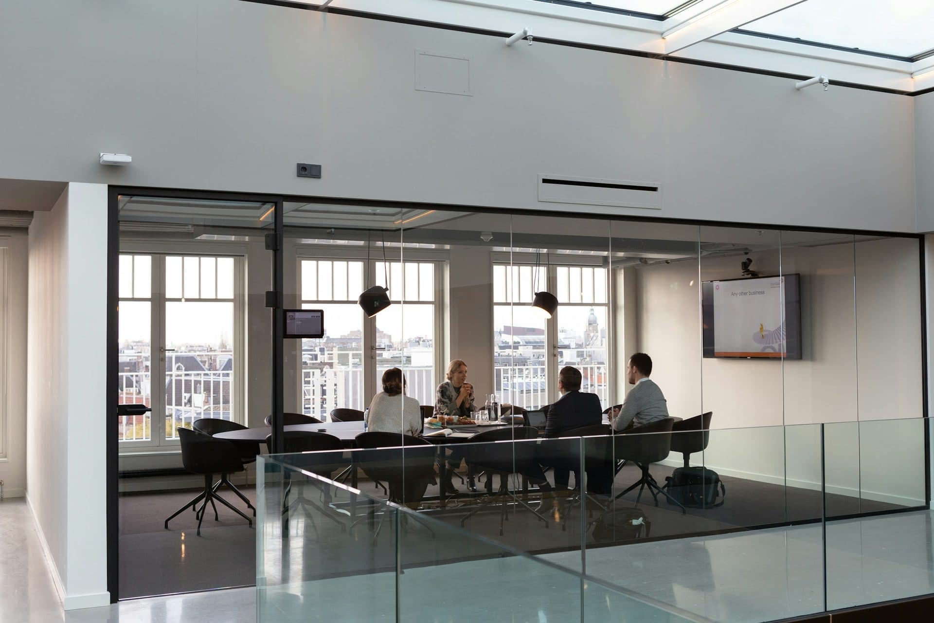 A modern glass-walled office meeting space
